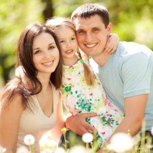 Familie sitzt in der Wiese
