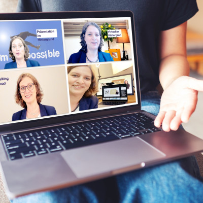 Mockup image of laptop with blank white screen on wooden table with a woman open hand for business presentation